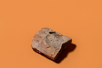 Decorative stone podium on brown background