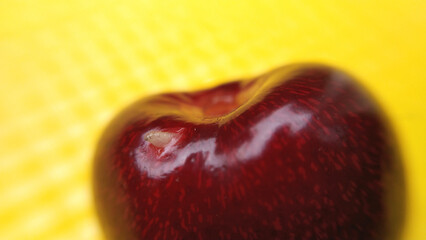 red, ripe cherry on a yellow background. delicious, juicy summer berry. healthy fruit rich in vitamins and antioxidants for dessert for children and adults