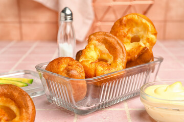 Baking dish with tasty Yorkshire pudding on table