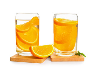 Glasses of infused water with orange slices on white background