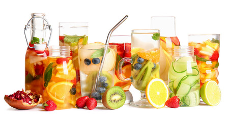 Glasses and bottles of infused water with different sliced fruits on white background