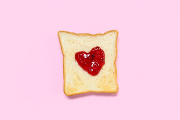 Toast with sweet jam on pink background