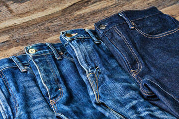 Faded Blue Jeans on Wooden Table