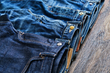 Faded Blue Jeans on Wooden Table