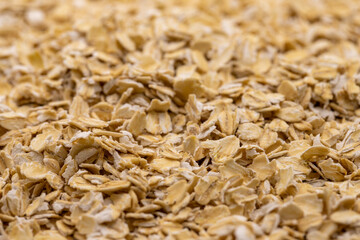 Pile of oatmeal or oat flakes as background. Close-up oatmeal