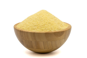 Dry organic semolina flour isolated on white background. Uncooked organic semolina in wooden bowl