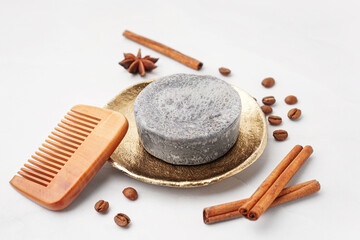 Handmade solid shampoo, hair comb and spices on light background, closeup