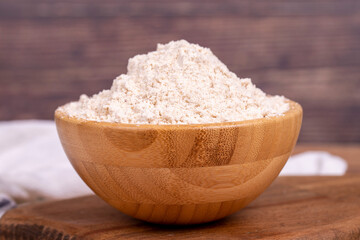 Mahlep powder on wooden background. Mahlep powder in wooden bowl. Close up