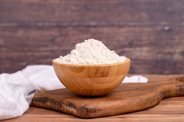 Mahlep powder on wooden background. Mahlep powder in wooden bowl