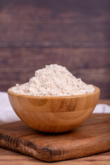 Mahlep powder on wooden background. Mahlep powder in wooden bowl. Close up