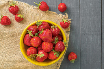 Fresh strawberry is on a dark wooden background