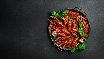 Freshly boiled red crayfish on a metal kitchen tray. Seafood, beer snacks. Free space for text.