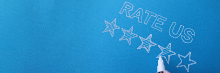 Handwritten review rate us and star rating on blue background. Customer feedback and service...