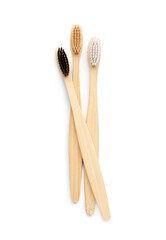 Different bamboo toothbrushes on white background