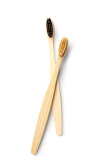 Different bamboo toothbrushes on white background