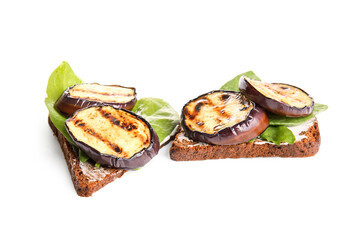 Toasts with delicious grilled eggplants on white background