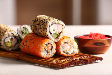Tasty sushi rolls  on table