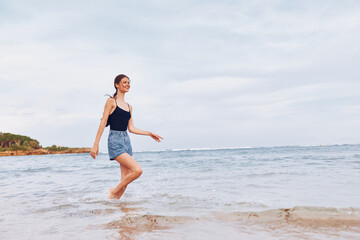 Fototapeta premium ocean woman young beach sea smile lifestyle summer running sunset travel