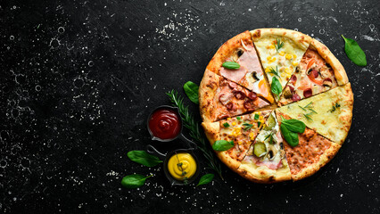 Pizza banner. Set of different pieces of pizza and ingredients on a black stone background. Top...