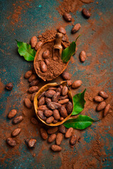 Cocoa powder and cocoa beans in a wooden bowl. On a dark background. Top view.