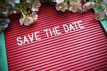 Save the Date text on Letter Board with flower decoration