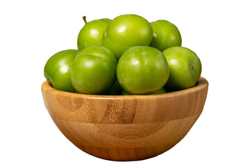 Green plum in bowl. Organic farm products. Fresh plum isolated on white background. Close up