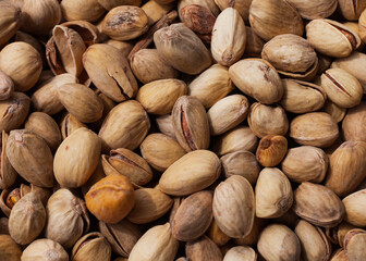 salted pistachios are on the table, a macro photograph of nuts