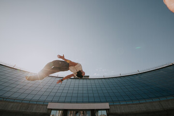 Parkour. Athlete performs tricks in the city.