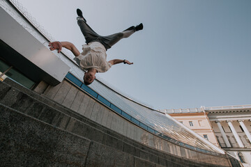 Parkour. Athlete performs tricks in the city.