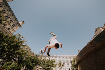 Parkour. Athlete performs tricks in the city.