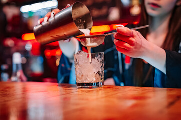 woman hand bartender making cocktail on the bar counter