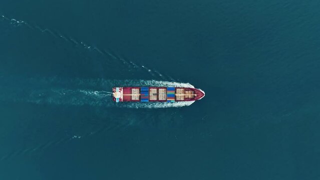 Cargo container Ship, cargo maritime ship with contrail in the ocean ship carrying container and running for export  concept technology freight shipping sea freight by Express Ship. top view 