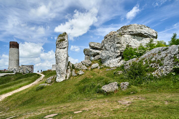 Limestone rocks and ruins of a medieval castle with a tower in Olsztyn