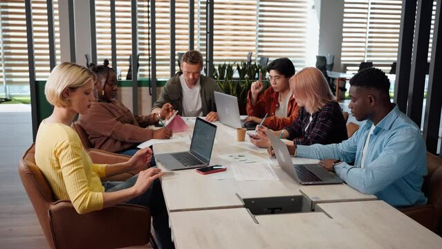 Office Day. Diverse multi ethnic group of business people analyzing sales growth in office interior