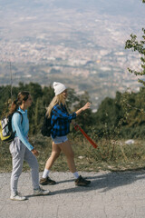 Blonde hiking girl pointing and explaining something to her friend