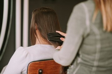 Close up of hairdresser brushing hair