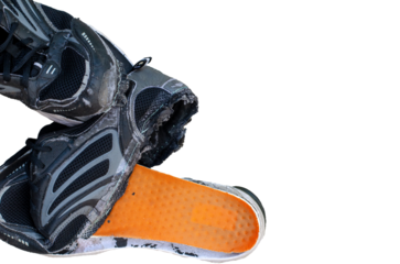 Torn old black shoes on transparent background