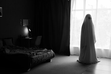 Silhouette of ghost in window inside bedroom at night. Horror scene. Halloween concept.