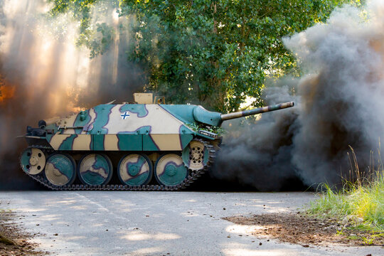 Jagdpanzer 38 German World War II armored tank on the battlefield amidst smoke and dust.  