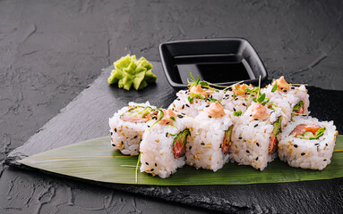 traditional japanese dish rolls with cucumbers and red salmon and onigiri soy sause