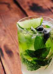 glass of fresh Mojito on wooden