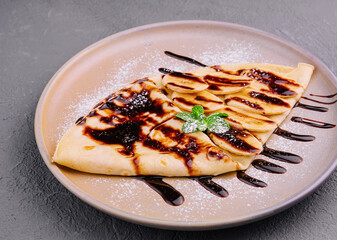 Crepes with fresh banana slaces and dark chocolate