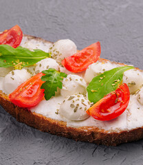 Caprese bruschetta toasts with cherry tomatoes