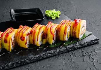 delicious sushi rolls with yellow pickled radish on the plate