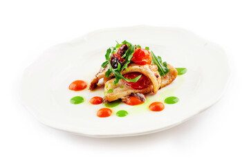Fried white fish fillet with tomatoes and arugula