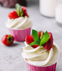Vanilla cupcake with white cream and strawberries