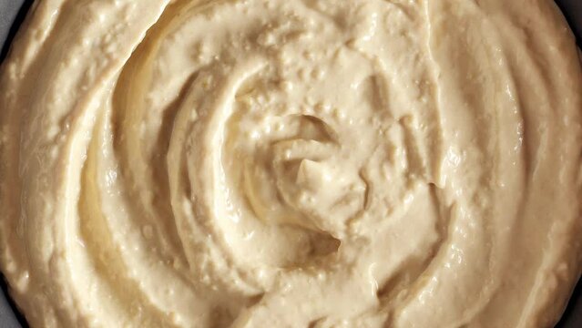 Hummus in bowl, rotating, turning, close-up macro, top view
