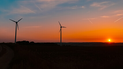 Obraz premium Sunset with wind power plant silhouettes near Kugl, Simbach, Dingolfing-Landau, Bavaria, Germany