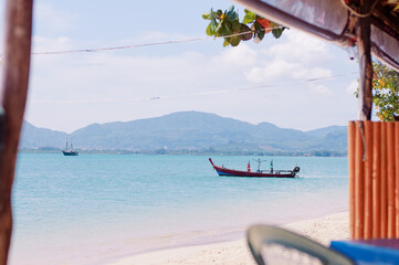 Tropical beach with longtail boat.