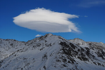Snowy mountain peak with cloud in the Caucasus